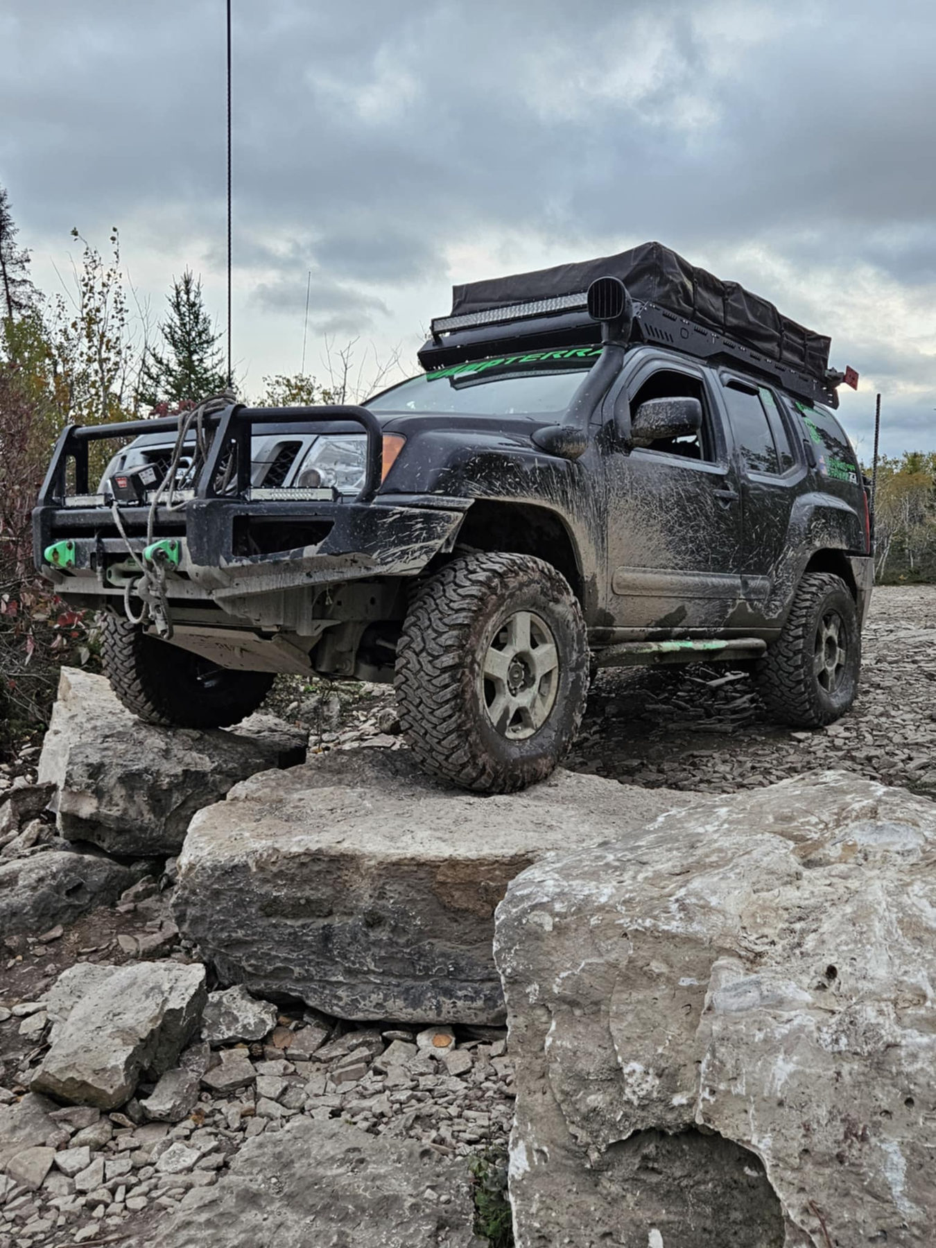 Spencer's off-road truck perched on a rock ledge