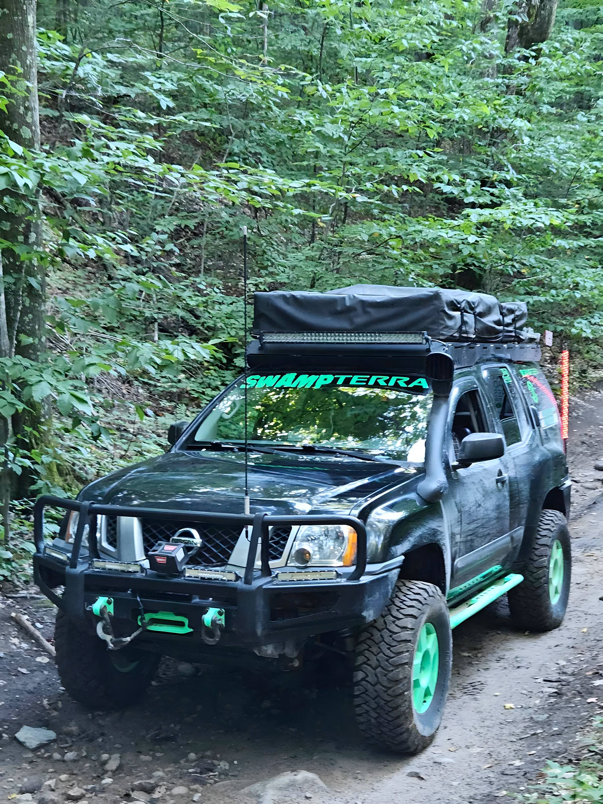 Truck climbing a wooded two-track